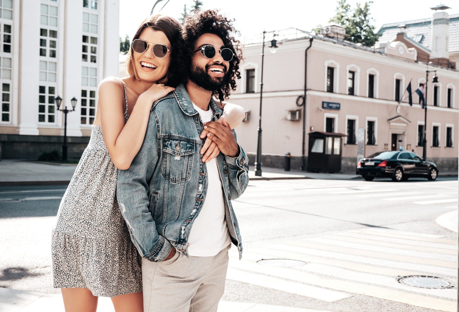 Smiling couple wearing sunglasses outside