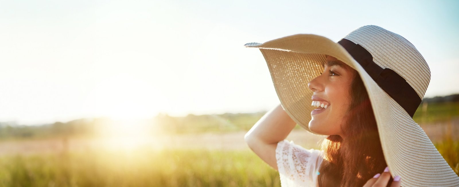 Two people in sun hats smiling outdoors