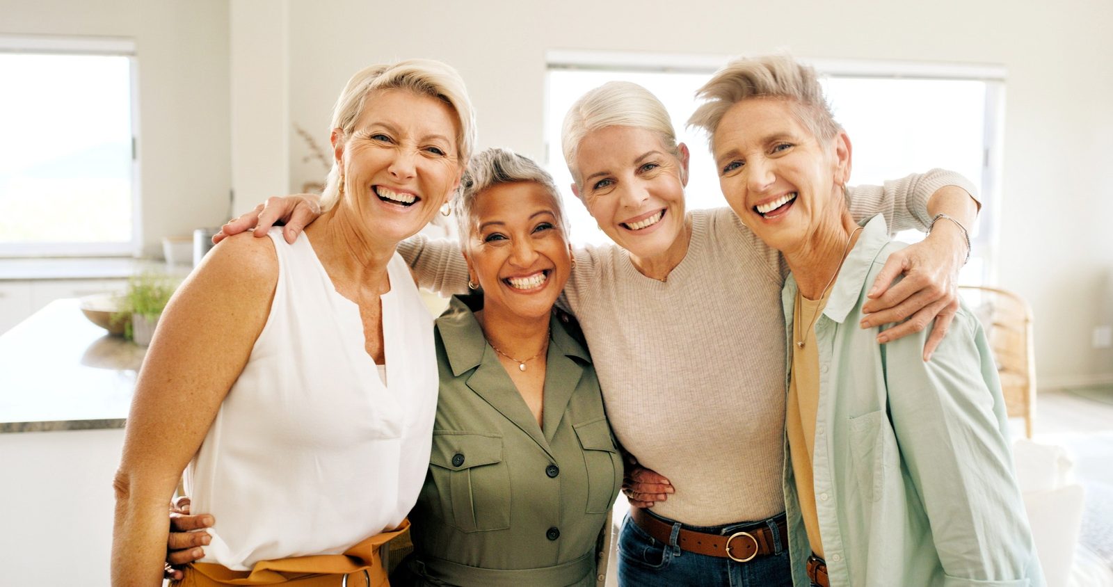 A group of older adults smiling together in a bright room