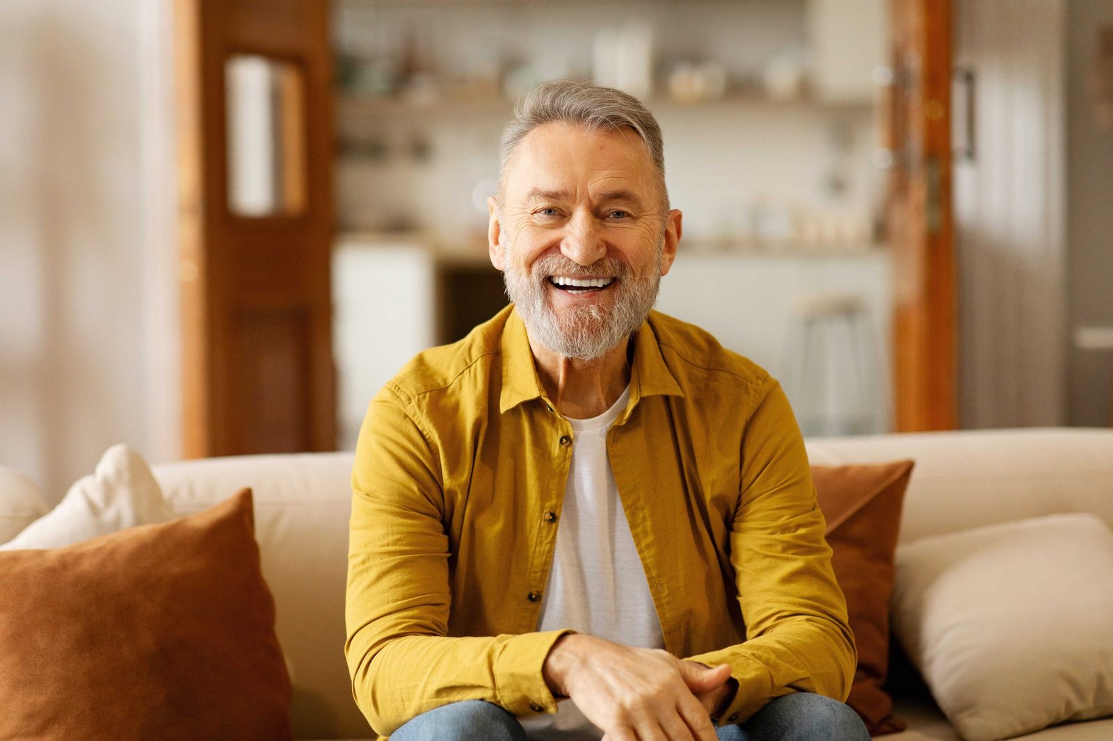 Distinguished older adult smiling naturally in a warm dental office